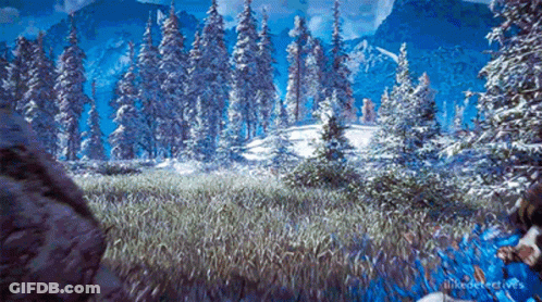 A Snowy Forest With Trees Covered In Snow And Mountains In The Background . GIF