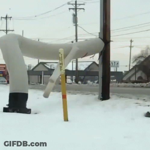 A Snowy Street With A Sign That Says ' Stop ' On It GIF