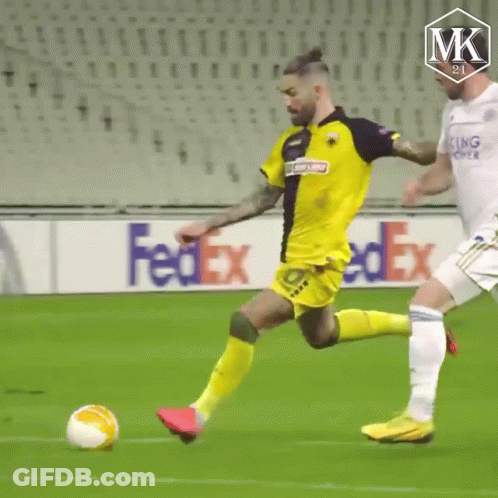 A Soccer Ball Is Being Kicked On A Field With A Fedex Ad In The Background . GIF