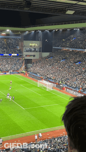 A Soccer Field With A Mastercard Banner On The Side GIF