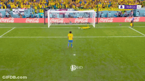 A Soccer Field With Coca Cola Advertisements On The Walls GIF