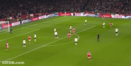 A Soccer Field With Emirates Advertisements On The Side GIF