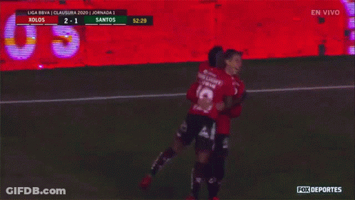 A Soccer Game Is Being Played Between Xolos And Santos And The Players Are Hugging GIF