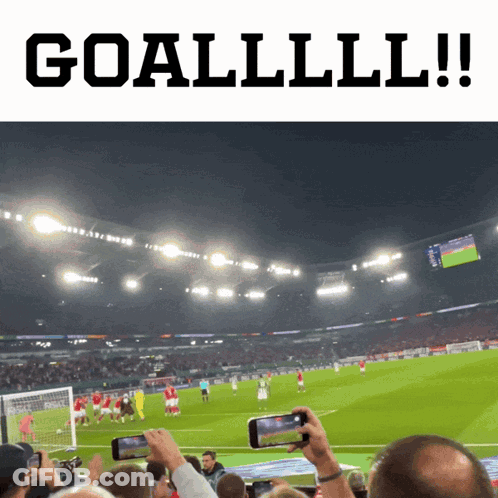 A Soccer Game Is Being Played In A Stadium And People Are Taking Pictures Of It GIF