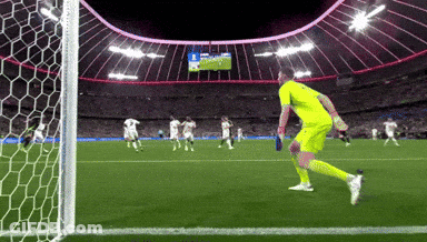 A Soccer Game Is Being Played In A Stadium And The Goalie Is Wearing A Yellow Uniform GIF
