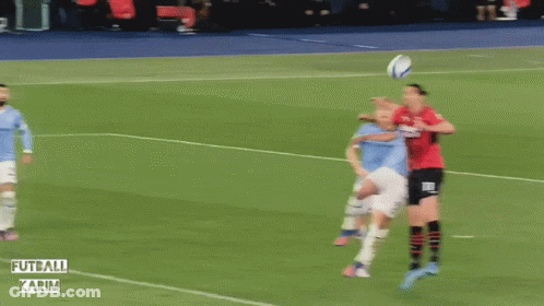 A Soccer Game Is Being Played In A Stadium That Says Futball Karim On The Side GIF
