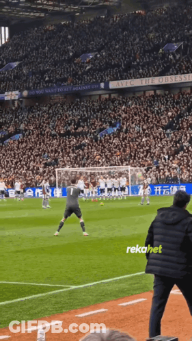A Soccer Game Is Being Played In A Stadium With A Sign That Says Live The Obsession GIF