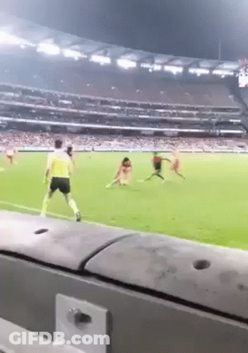 A Soccer Game Is Being Played In A Stadium With People Playing On The Field . GIF