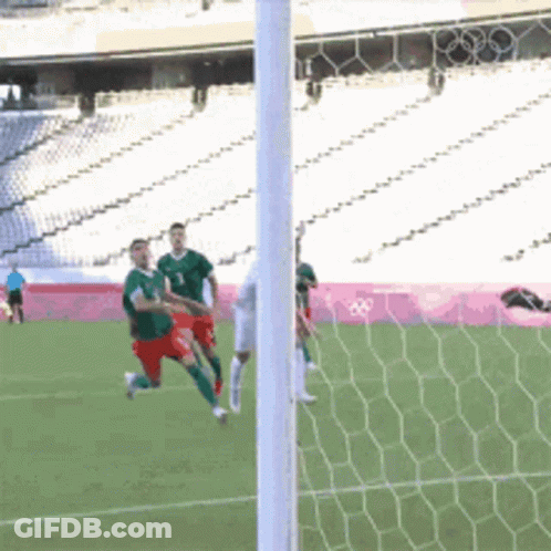 A Soccer Game Is Being Played In A Stadium With The Olympics Logo In The Background GIF