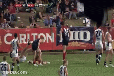 A Soccer Game Is Being Played In Front Of A Banner That Says Carlton Id GIF