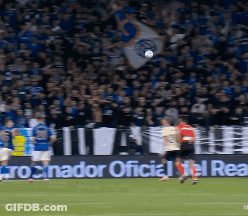 A Soccer Game Is Being Played In Front Of A Banner That Says " Cronador Oficial Del Real " GIF