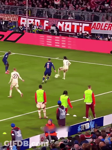 A Soccer Game Is Being Played In Front Of A Banner That Says Fanatic GIF