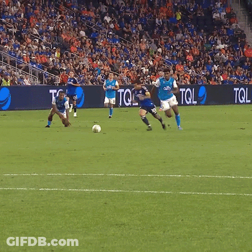 A Soccer Game Is Being Played In Front Of A Banner That Says Tol GIF