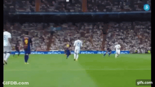 A Soccer Game Is Being Played In Front Of A Crowd GIF