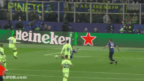 A Soccer Game Is Being Played In Front Of A Heineken Advertisement GIF