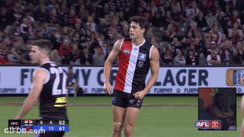 A Soccer Game Is Being Played In Front Of A Large Banner That Says Furphy Lager GIF