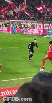 A Soccer Game Is Being Played In Front Of A Magenta Tv Sign GIF