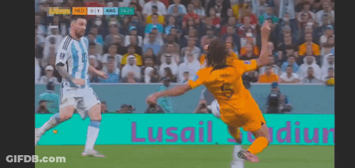 A Soccer Game Is Being Played In Front Of A Sign That Says Lusail Stadium GIF