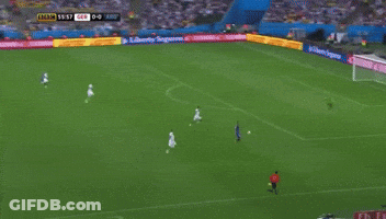 A Soccer Game Is Being Played In Front Of An Ad For Coca Cola GIF