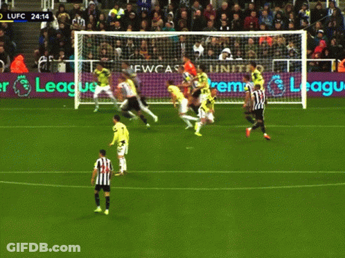 A Soccer Game Is Being Played In Front Of An Advertisement For Newcastle GIF