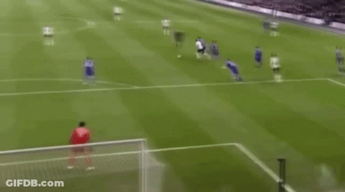 A Soccer Game Is Being Played On A Field And A Goalie Is Diving To Save A Goal . GIF