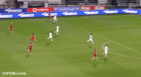 A Soccer Game Is Being Played On A Field With A Banner That Says Avance On It GIF