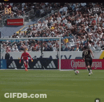A Soccer Game Is Being Played On A Field With A Captain Morgan Ad In The Background GIF