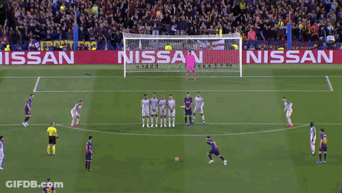 A Soccer Game Is Being Played On A Field With A Nissan Banner Behind The Goal GIF