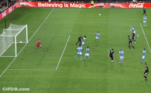 A Soccer Game Is Being Played On A Field With An Advertisement For Coca Cola GIF