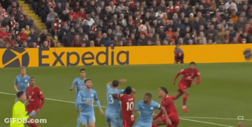 A Soccer Game Is Being Played On A Field With An Expedia Sign In The Background GIF