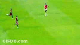 A Soccer Game Is Being Played On A Field With Players In Red And Black Uniforms GIF