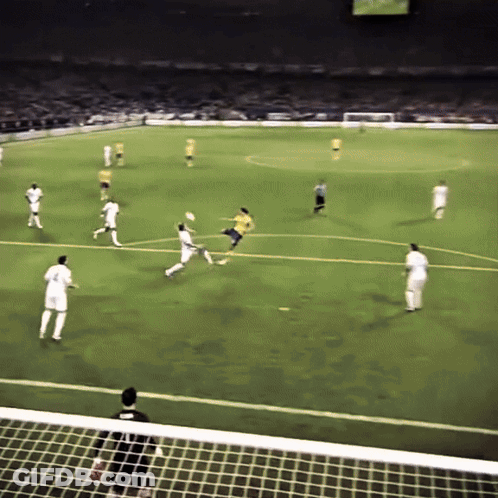 A Soccer Game Is Being Played On A Field With Players In White And Yellow GIF