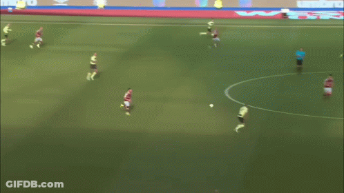 A Soccer Game Is Being Played On A Field With Umbro Ads On The Sidelines GIF
