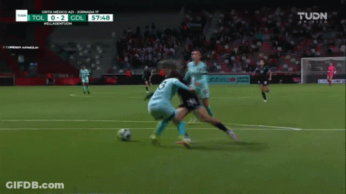 A Soccer Game Is Being Played On A Tv Screen That Says Tudn GIF