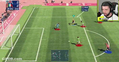 A Soccer Game Is Being Played On A Video Game With A Man Wearing Headphones In The Background . GIF