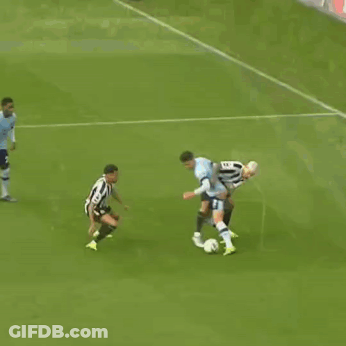 A Soccer Game Is Underway And A Goalie Is Diving To Catch A Ball GIF