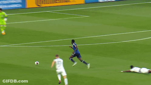 A Soccer Game Is Underway With A Heineken Ad In The Background GIF