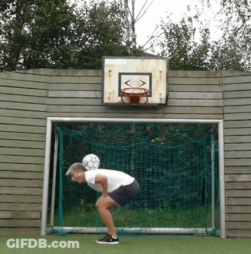 A Soccer Goal With A Basketball Hoop On The Wall Behind It GIF