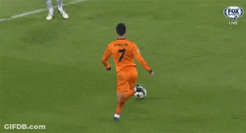 A Soccer Goalie Catches A Ball In Front Of A Heineken Advertisement GIF