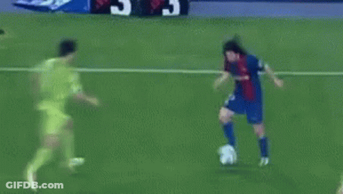 A Soccer Goalie Catches A Soccer Ball That Is Going Into The Net GIF