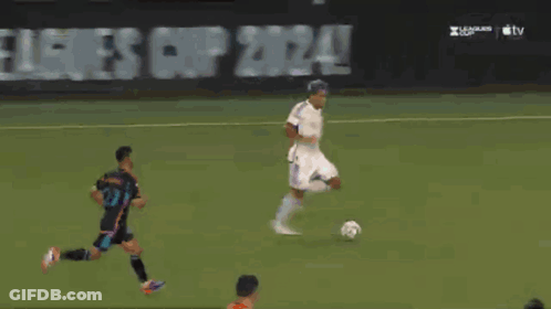 A Soccer Goalie Dives To Catch A Ball In Front Of An At & T Advertisement GIF