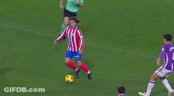 A Soccer Goalie In A Purple Jersey Is Diving To Block A Shot GIF
