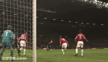 A Soccer Goalie Is Diving To Catch A Ball During A Game GIF