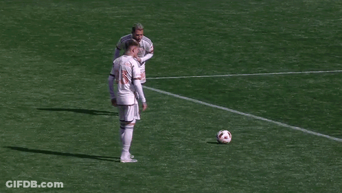 A Soccer Goalie Is Diving To Catch A Ball In Front Of A Target Sign GIF