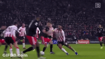 A Soccer Goalie Is Diving To Catch A Soccer Ball During A Game GIF