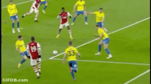 A Soccer Goalie Is Diving To Catch A Soccer Ball On A Field . GIF