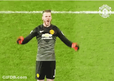 A Soccer Goalie Is Holding A Pair Of Red Dumbbells In His Hands On A Field . GIF