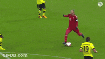 A Soccer Goalie Jumps In The Air To Catch A Soccer Ball With The Number 21 On It GIF