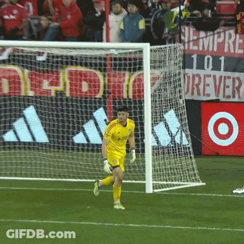 A Soccer Goalie Wearing A Yellow Adidas Jersey Runs Towards The Goal GIF