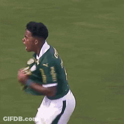 A Soccer Player Celebrates A Goal In Front Of A Banner That Says Retano GIF